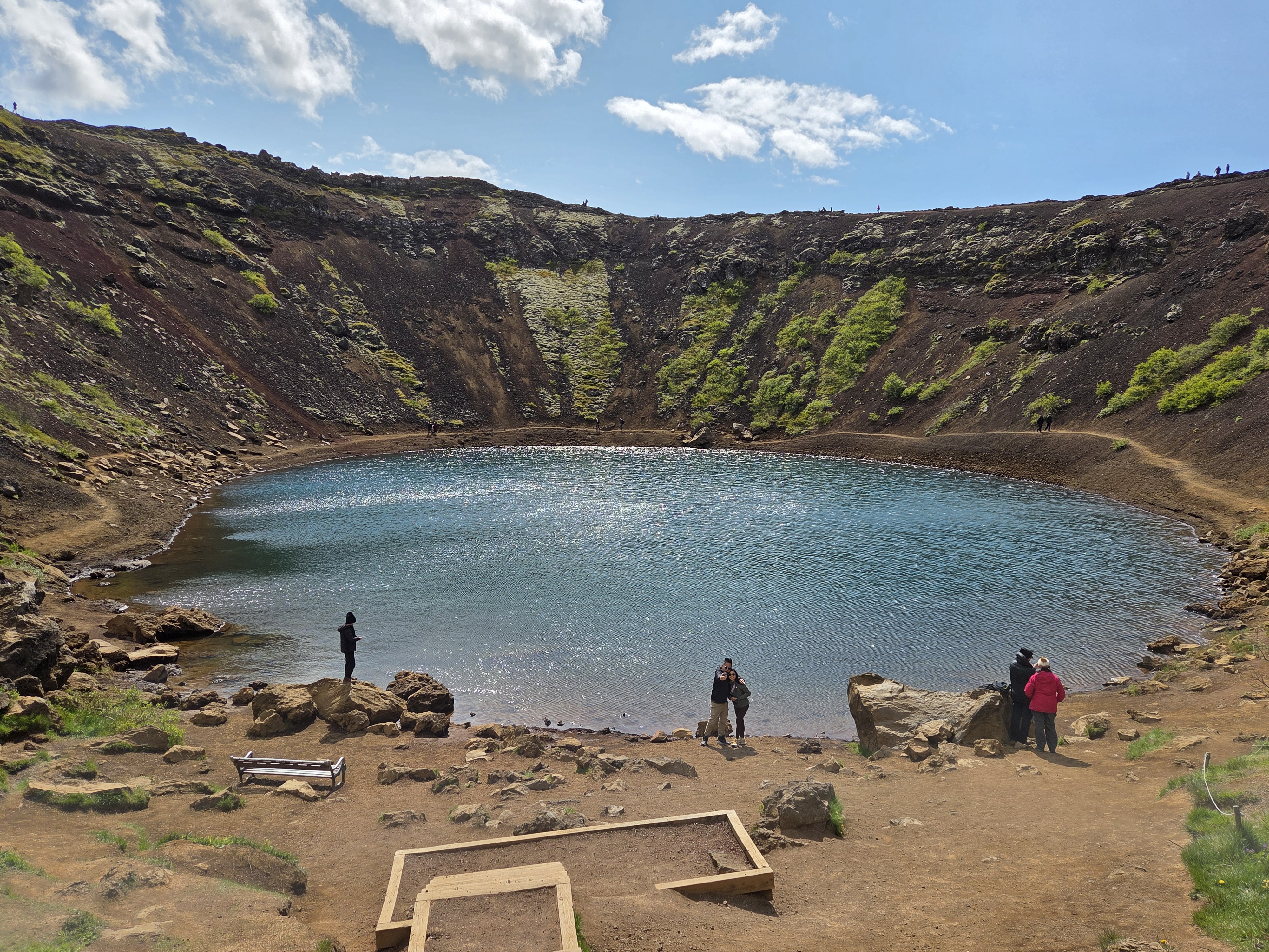Kerið lake from the bottom of the crater with steep volcanic walls rising above